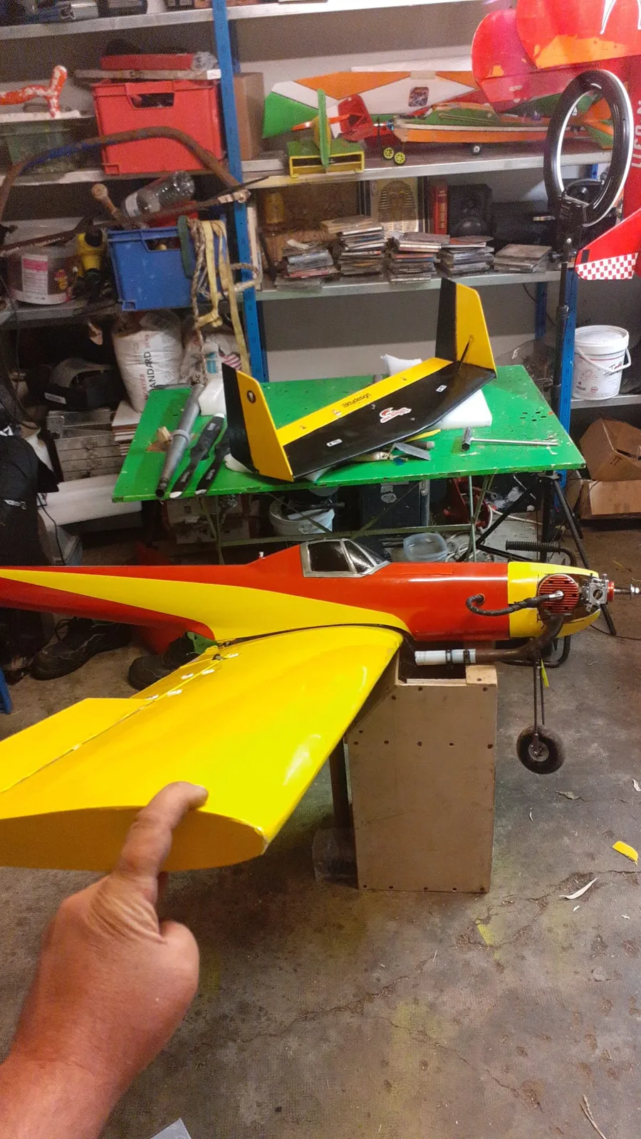 Aile jaune présentée près du fuselage rouge et jaune du Bison pendant le remontage.